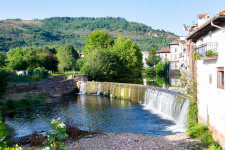 The landscape of Elizondo in Navarra with the BaztÃ¡n river. Elizondo is a town in the Foral Community of Navarra, located in the center of the BaztÃ¡n valley, on both sides of the BaztÃ¡n or Bidasoa riの写真素材