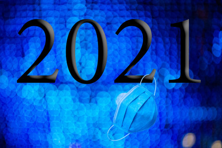 Text with the year number 2021 with a background of out-of-focus bright blue lights with Bokeh...