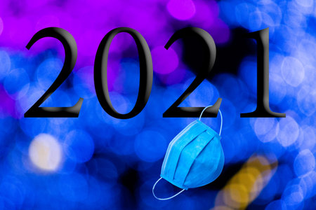 Text with the year number 2021 with a background of out-of-focus bright blue lights with Bokeh...
