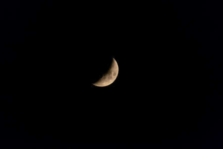 The crescent moon over the sky of Madrid, in Spain.の写真素材