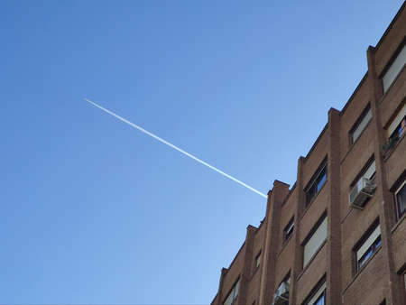 The white flash of the plane appearing through the building causing the lines to be cut, in Madrid, Spainの写真素材