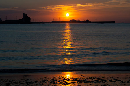 Sunset with orange color in the sky at Getxo-Guecho beach. Spanish municipality located on the coast...