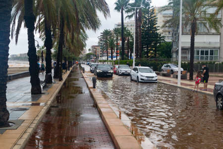 BENICÃSSIM - BENICÃSIM, SPAIN - AUGUST 29, 2021. Streets, promenades and beach flooded in the city of BenicÃ ssim after the rains and storms that flooded the town. Horizontal photography.のeditorial素材