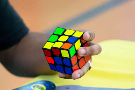 MADRID, SPAIN - SEPTEMBER 13, 2021. Close-up of hands solving a Rubik's Cube. Color puzzle.のeditorial素材
