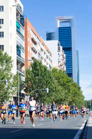 MADRID, SPAIN - SEPTEMBER 26, 2021. Racing car that opens the way to the runners of the half marathon that passes through the central streets of Madrid, in Spain. Europe. Horizontal photography.のeditorial素材