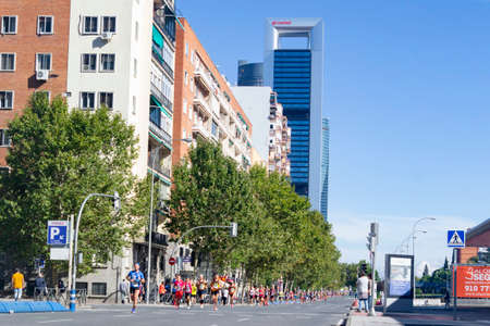 MADRID, SPAIN - SEPTEMBER 26, 2021. Racing car that opens the way to the runners of the half marathon that passes through the central streets of Madrid, in Spain. Europe. Horizontal photography.のeditorial素材