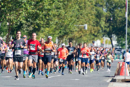 MADRID, SPAIN - SEPTEMBER 26, 2021. Racing car that opens the way to the runners of the half marathon that passes through the central streets of Madrid, in Spain. Europe. Horizontal photography.のeditorial素材