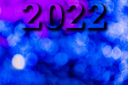 New Year, 2022. Translucent numbers of the year on a blue-toned background of bright lights out of...