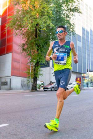 MADRID, SPAIN - NOVEMBER 14, 2021. Professional athletes running the Movistar Half Marathon of Madrid through the most central streets of the capital of Spain. In Europe.のeditorial素材