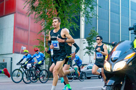 MADRID, SPAIN - NOVEMBER 14, 2021. Professional athletes running the Movistar Half Marathon of Madrid through the most central streets of the capital of Spain. In Europe.のeditorial素材