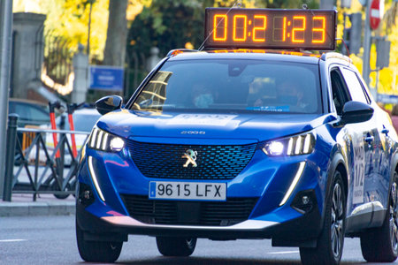 MADRID, SPAIN - NOVEMBER 14, 2021. Blue car with race timer on the roof for an athletics competition...
