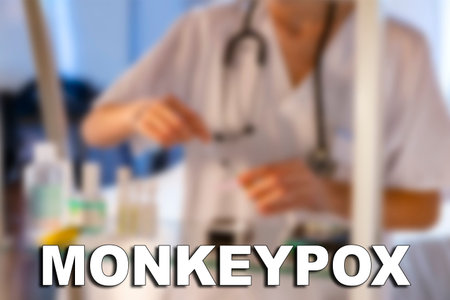 Monkeypox. Nurse. Medical. Text written on an unfocused background of a nurse with an injection to...