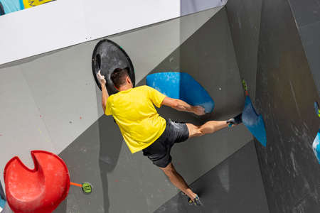 climbing. Young person climbing in the Madrid Block Climbing Spanish Cup held in Madrid's Plaza de EspaÃ±a. Climbers.のeditorial素材