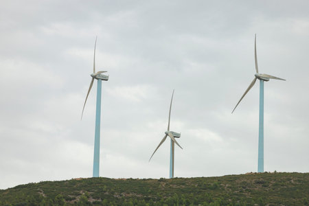 Wind turbines. Windmill in motion generating clean and renewable energy on a cloudy day, in Spain....