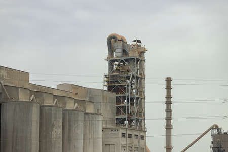 Factory. Cement factory seen from the outside on a cloudy day, in Spain. Europe. Horizontal photography.の写真素材