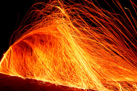 Fire. Realistic fire flame with smoke, blue fire and transparent sparkles on the dark background. Red fire flames ignite, fire silhouette burns. Black background.の写真素材