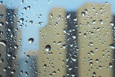 Rain. Raindrops on the window. Rainy day. Blue tone. Drops of water on the glass. Macro shooting. Texture. Concept of autumn weather, background of drops of water rain on glass traの写真素材