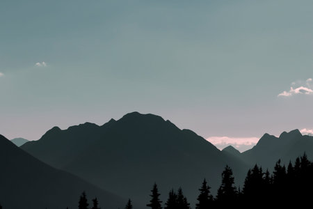 Silhouettes of mountains with an orange color of sunset and sunrise. Forest silhouettes. Mountain landscape.の写真素材