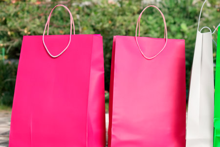 Shopping bags. Sales concept. For sale. Shopping bags of women crazy shopaholic person at shopping mall. Colorful paper shopping bags. Paper shopping bagsの素材
