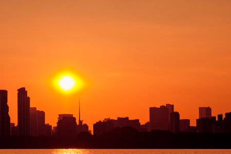 Heat wave. Hot sun of heat wave. Climate change. Global warming. High temperature thermometer. Heat wave in Europe. California. Heat wave over the city skyline. Climate change.の素材