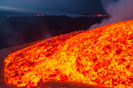 Etna. They overturn with magma on the walls of the volcanic cone. Hot wash. New eruption. 2023. Hot rocks.の素材