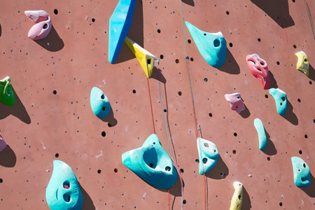 Climbing wall with colorful climbing equipment, closeup of photoの写真素材
