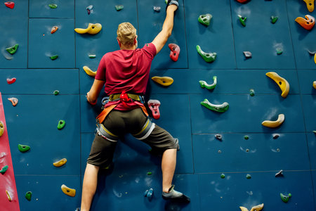 Climber hanging on a climbing wall in an indoor climbing gym