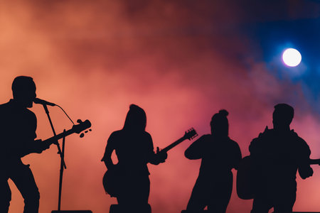 Concert. Festival rock together singing people group unrecognizable musicians silhouettes stage concert playing band music silhouette light song.の写真素材