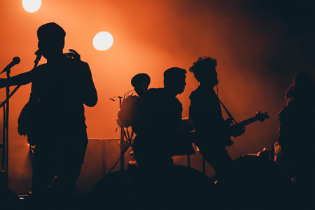 Concert. Festival rock together singing people group unrecognizable musicians silhouettes stage...