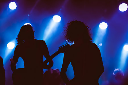 Concert. Festival rock together singing people group unrecognizable musicians silhouettes stage concert playing band music silhouette light song.の写真素材