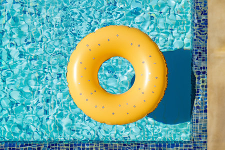 Swimming pool. Inflatable floating in swimming pool on sunny day. Top view. With space for text....