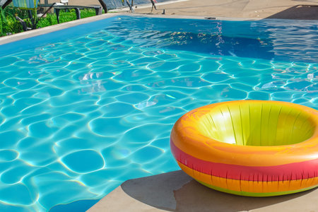 Swimming pool. Inflatable floating in swimming pool on sunny day. Top view. With space for text....