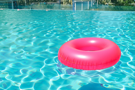 Swimming pool. Inflatable floating in swimming pool on sunny day. Top view. With space for text....