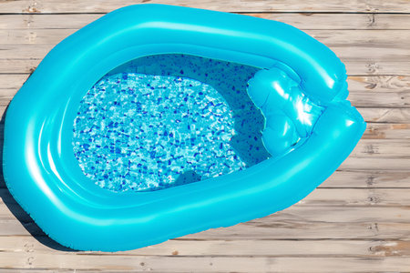 Swimming pool. Inflatable floating in swimming pool on sunny day. Top view. With space for text. Summer color concept. Summer and heat concept.の写真素材