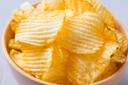 Chips. Potato chips levitate on a white background. Natural potato chips isolated. Potato chips piled up. Potato chips in bowl. Fast food.の写真素材