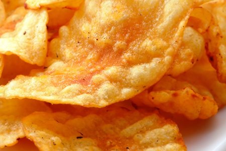 Chips. Potato chips levitate on a white background. Natural potato chips isolated. Potato chips piled up. Potato chips in bowl. Fast food.の写真素材