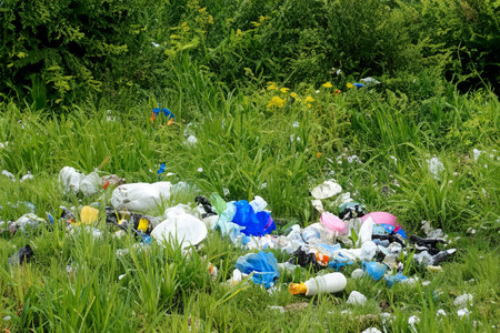 Rubbish. Liter. Garbage in nature. Group of eco volunteers picking up plastic trash in park....