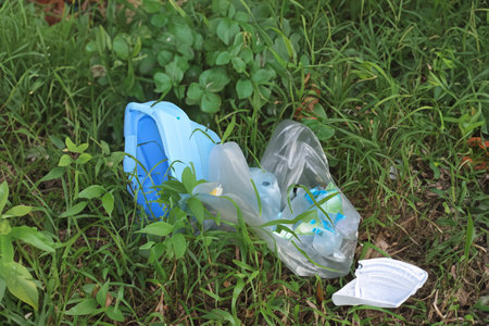 Rubbish. Liter. Garbage in nature. Group of eco volunteers picking up plastic trash in park....