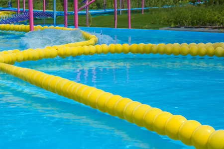Swimming pool. Inflatable floating in swimming pool on sunny day. Top view. With space for text. Summer color concept. Summer and heat concept.の写真素材