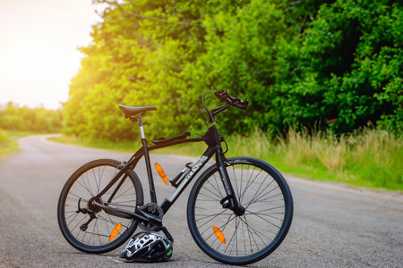Bike. Bicycle. Road bike parked on a beautiful road sunset, warm light with copy space. Road bike parked on a beautiful road sunset, warm light. World bicycle day.の写真素材