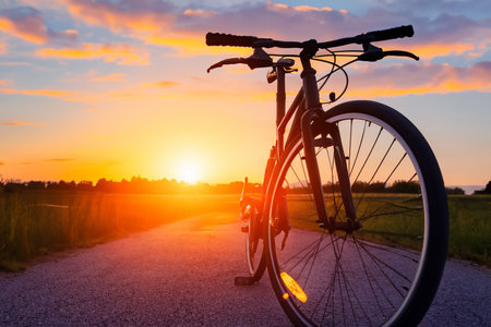 Bike. Bicycle. Road bike parked on a beautiful road sunset, warm light with copy space. Road bike parked on a beautiful road sunset, warm light. World bicycle day.の写真素材