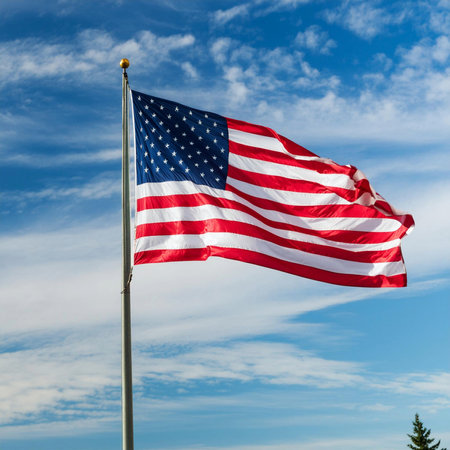 Flag USA. 4July. American flag blowing in the wind with a partly cloudy blue sky. USA flag in Chicago with with skyscrapers on background. Independence day celebration. 4th of julyの写真素材