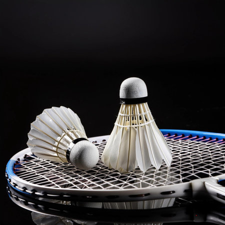 Shuttlecock and badminton racket on black background, sport conceptの写真素材