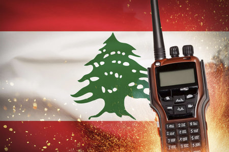 Walkie talkies. Lebanon flag. Burst. Conflict between Lebanon and Israel. Hezbollah leader warns Israel against extending war to Lebanon. Explosion in portable radios. Explosionの写真素材