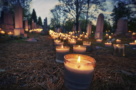 Candles in the cemetery at sunset. Selective focus on candles.の写真素材