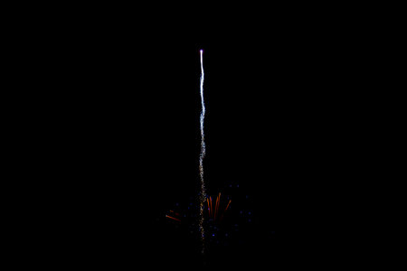 Fireworks. Colorful celebration fireworks isolated on a black sky background. From below, shot of wonderful and vivid fireworks exploding.の写真素材