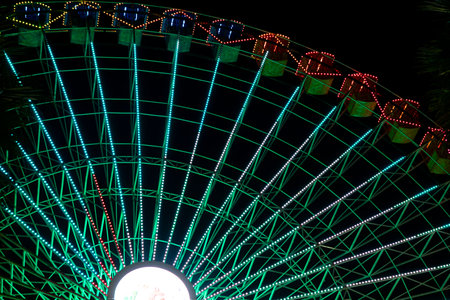 Ferris wheel. Noria. Christmas lights in Vigo, Pontevedra. Christmas decorations. Tourists strolling through its streets. Ferris wheel in the dark showing neon colors.の写真素材