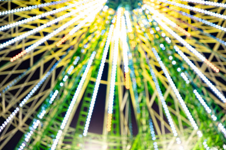 Ferris wheel. Noria. Christmas lights in Vigo, Pontevedra. Christmas decorations. Tourists strolling through its streets. Ferris wheel in the dark showing neon colors.の写真素材