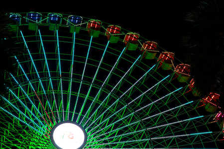 Ferris wheel. Noria. Christmas lights in Vigo, Pontevedra. Christmas decorations. Tourists strolling through its streets. Ferris wheel in the dark showing neon colors. VIGO. SPAIN.の写真素材