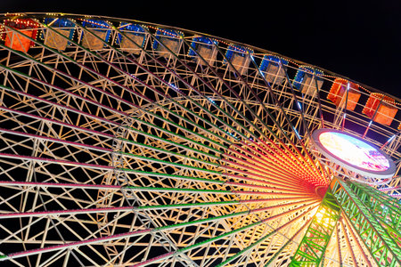 Ferris wheel. Noria. Christmas lights in Vigo, Pontevedra. Christmas decorations. Tourists strolling through its streets. Ferris wheel in the dark showing neon colors.の写真素材